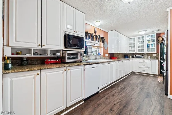 a kitchen with stainless steel appliances granite countertop a sink and cabinets
