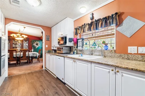 a kitchen with stainless steel appliances granite countertop a sink and cabinets