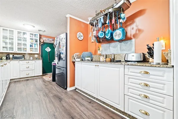 a kitchen view of counter top space and wooden floor