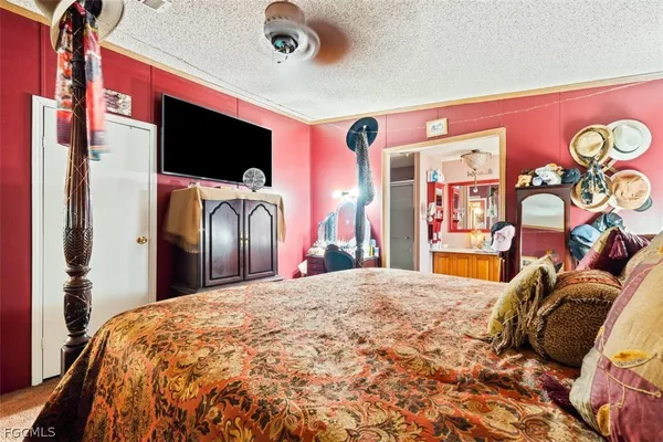 a bed sitting in a bedroom and flat screen tv