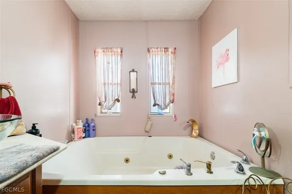 a bathroom with a tub and window