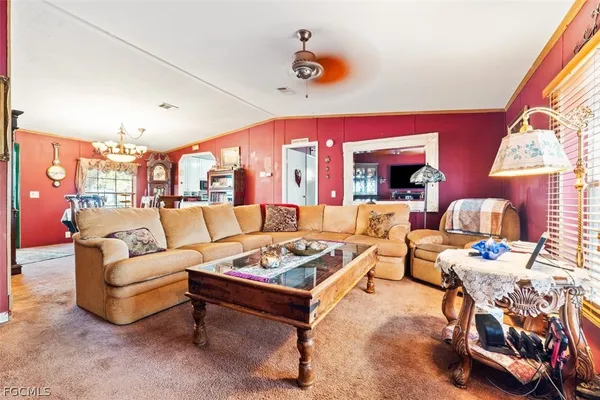 a living room with furniture a rug and a large window