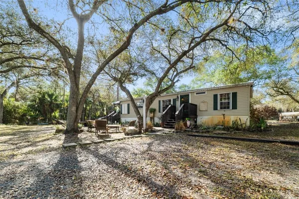 a view of a house with a yard covered in snow