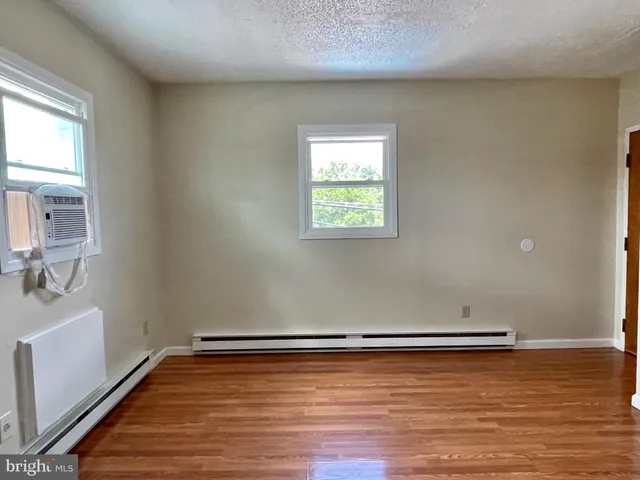 a view of a room with wooden floor and window