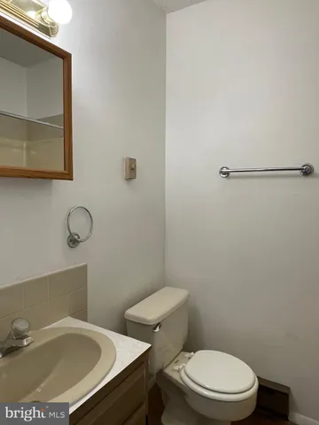 a white toilet sitting next to a bathroom sink