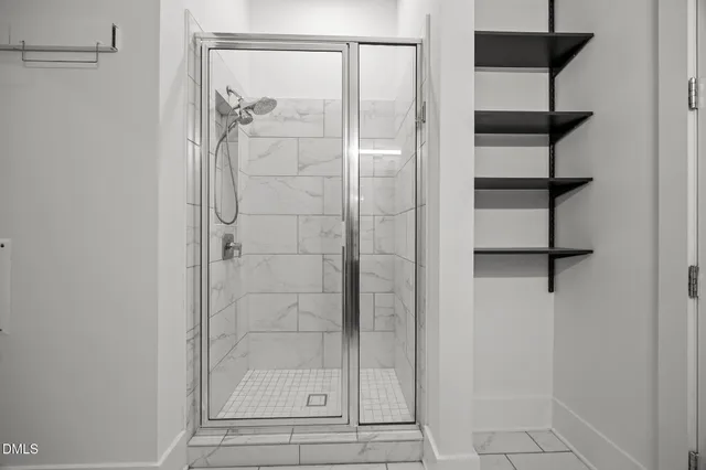 a bathroom with a glass shower door