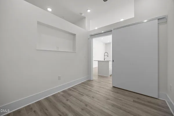 a view of empty room with wooden floor