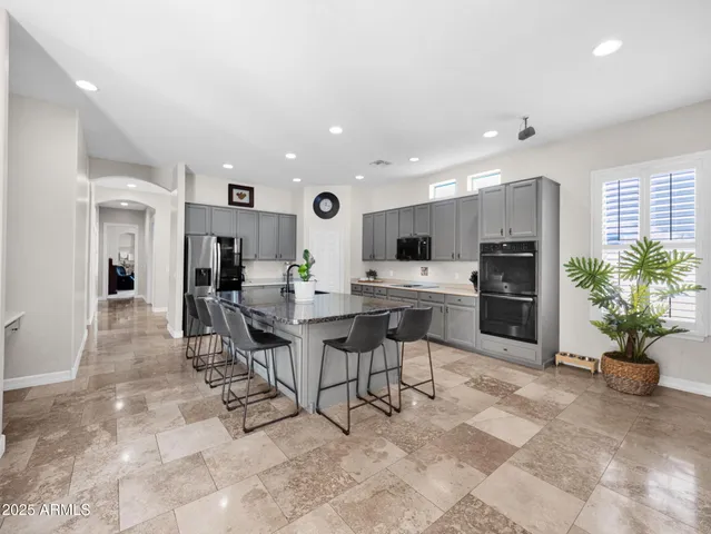 a kitchen with a sink stainless steel appliances and cabinets
