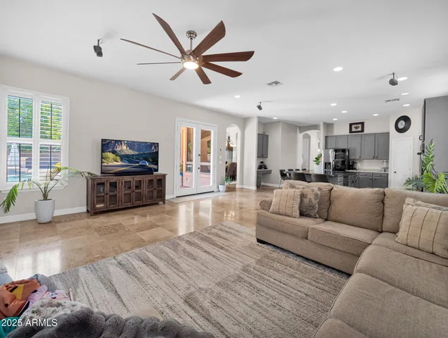 a spacious bedroom with a bed a couch and a window