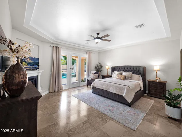 a spacious bathroom with a double vanity sink a mirror a bathtub and window