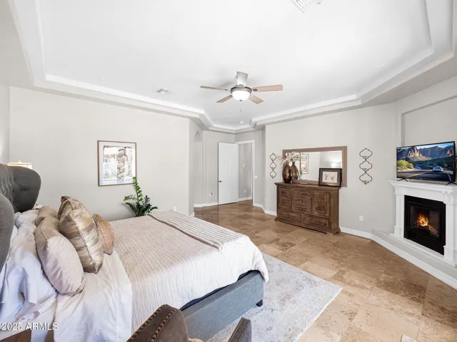 a spacious bedroom with a bed and a chandelier