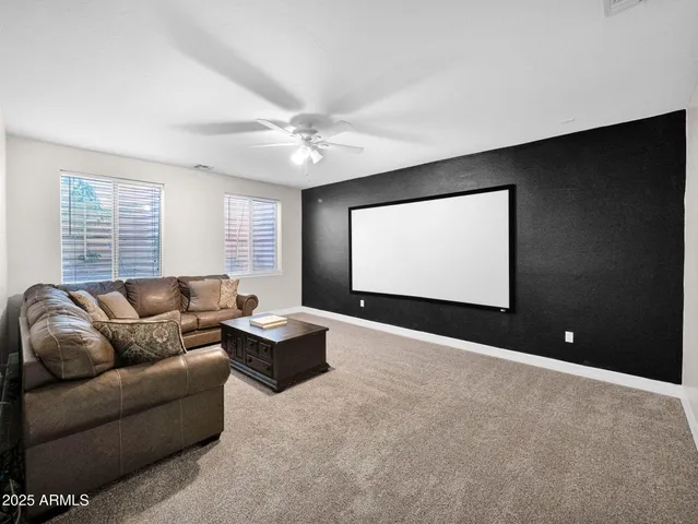 a dining room with furniture potted plants and a flat screen tv