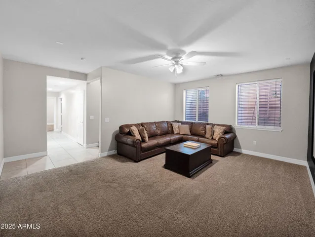 a view of a backyard with table and chairs potted plants and palm trees