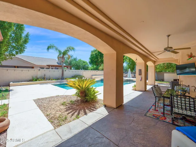 a swimming pool with outdoor seating and yard