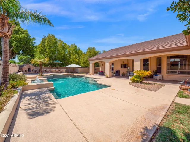 an aerial view of a house with yard swimming pool and outdoor seating