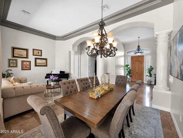 a kitchen with granite countertop a counter space dining table and stainless steel appliances