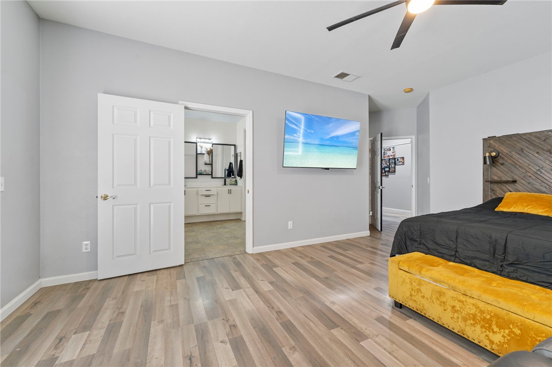 3155 Shipley Place Hemet, CA 92545 - Photo 13 of 26 a bedroom with a bed and painting on the wall