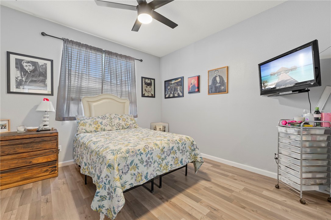 3155 Shipley Place Hemet, CA 92545 - Photo 17 of 26 a bedroom with a bed and wooden floor