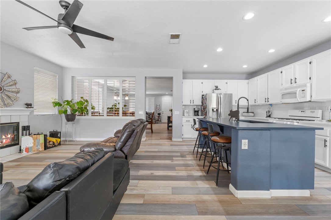 3155 Shipley Place Hemet, CA 92545 - Photo 6 of 26 a living room with stainless steel appliances kitchen island furniture and a view of kitchen