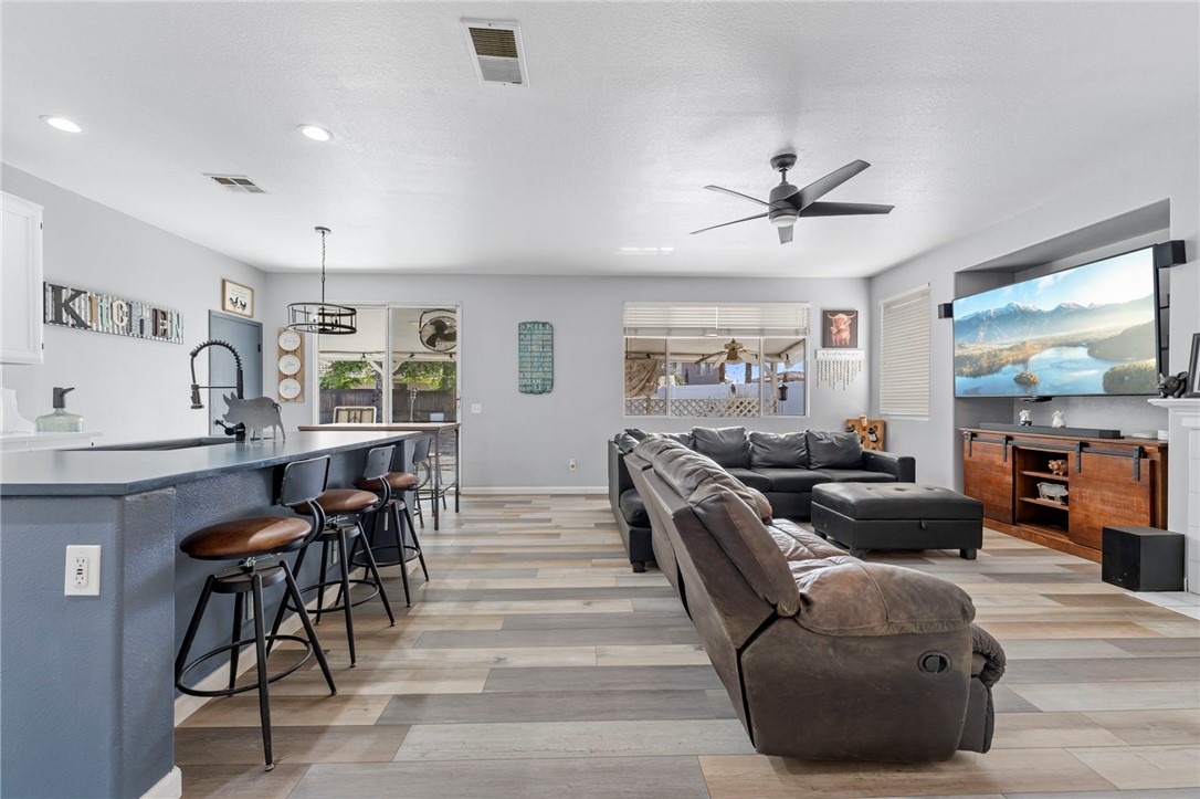 3155 Shipley Place Hemet, CA 92545 - Photo 7 of 26 a living room with furniture a large window and stainless steel appliances