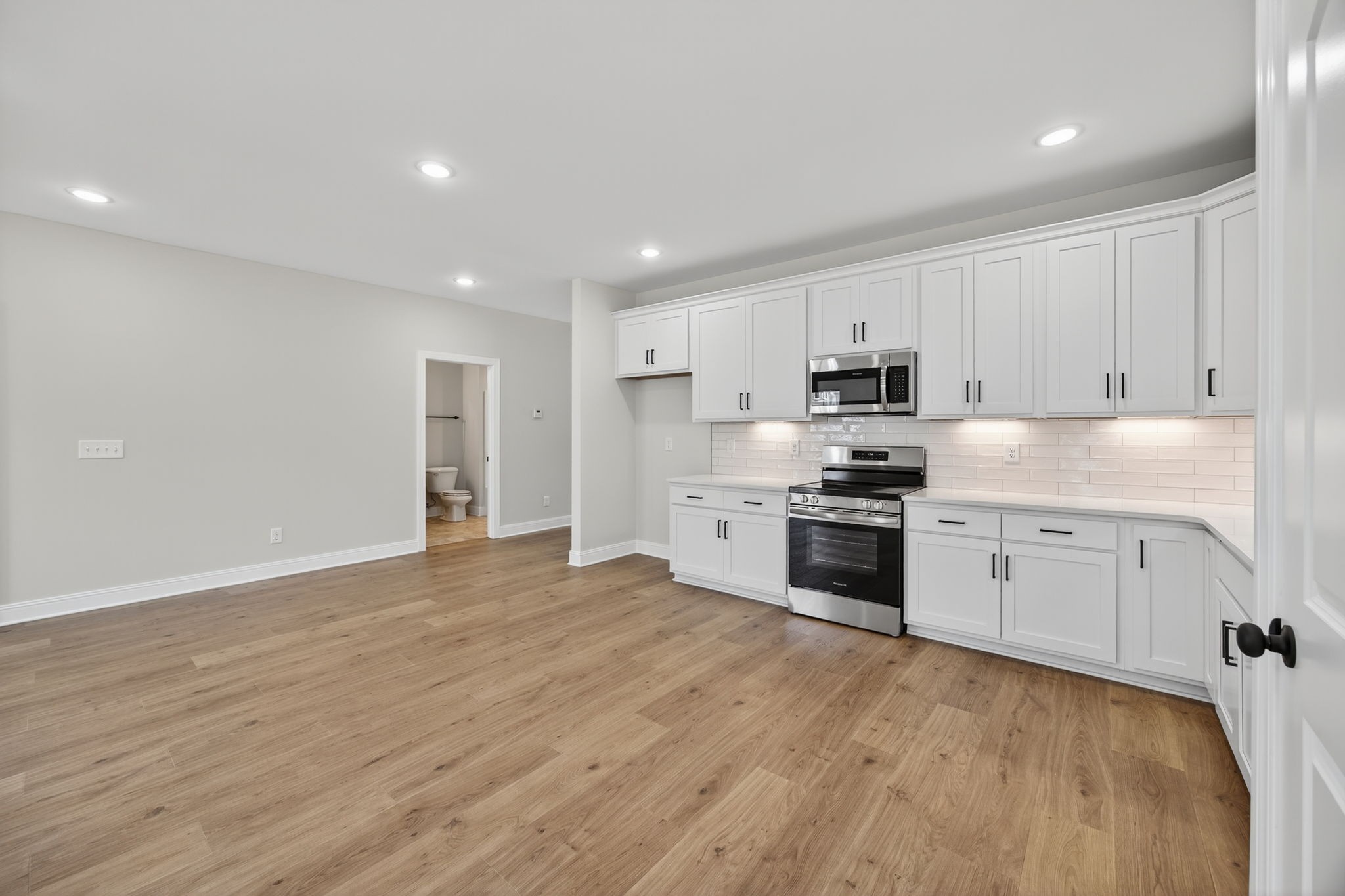2140 Rylee Way, Unit 45 Greenbrier, TN 37073 - Photo 23 of 42 a kitchen with granite countertop white cabinets and stainless steel appliances