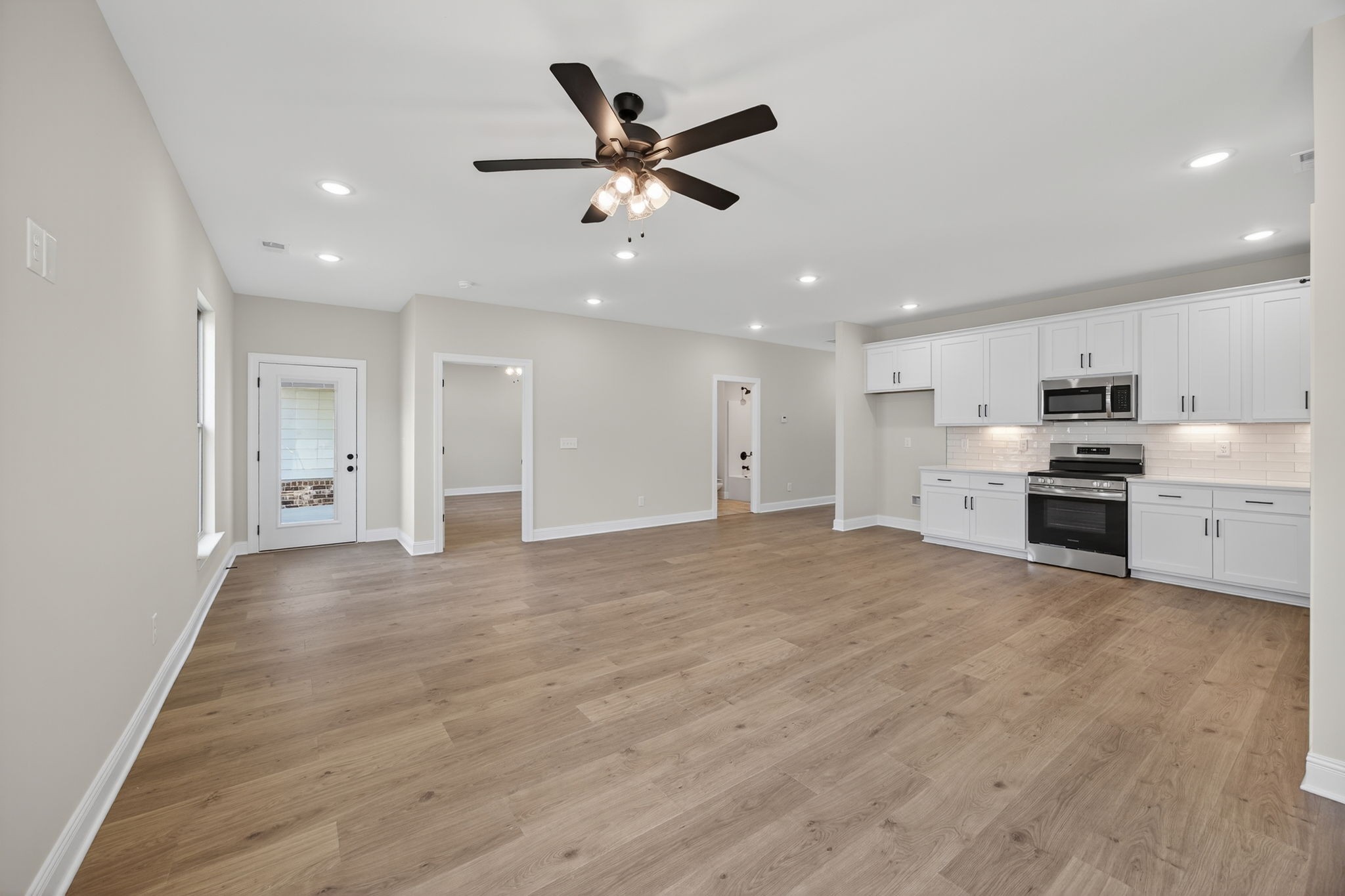 2140 Rylee Way, Unit 45 Greenbrier, TN 37073 - Photo 26 of 42 a view of an empty room with kitchen ceiling fan and wooden floor