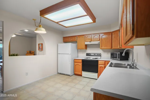 a kitchen with stainless steel appliances granite countertop a stove a sink dishwasher and a refrigerator