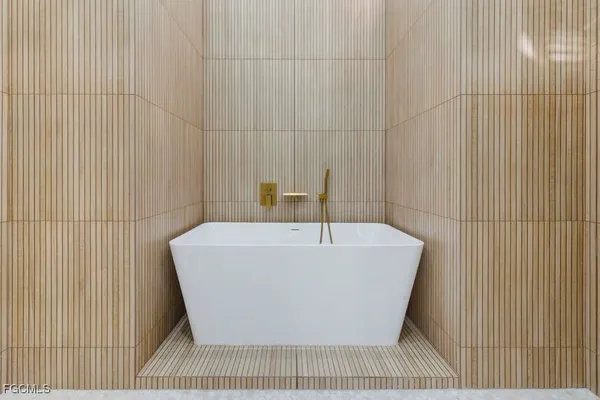 a white bath tub sitting in a bathroom