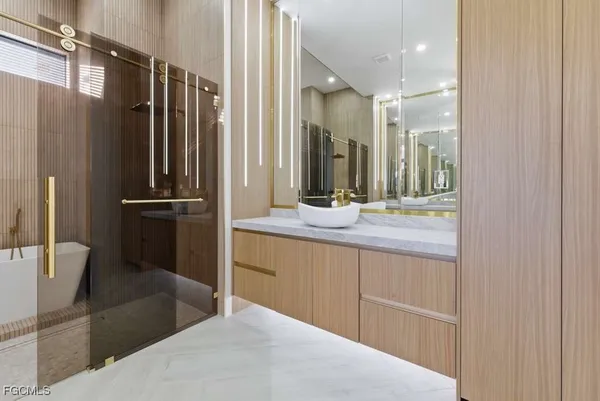a bathroom with a double vanity sink toilet and shower