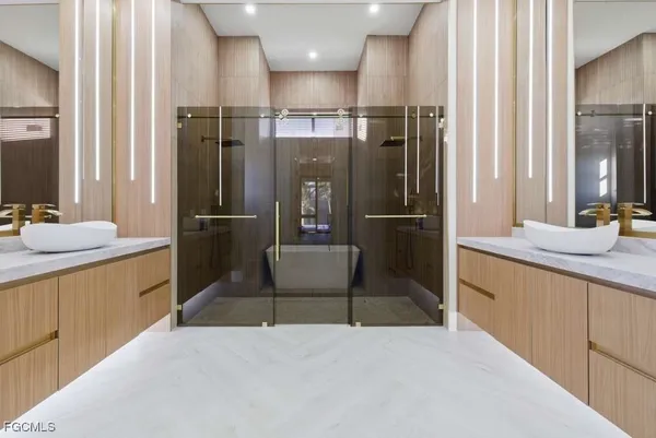 a kitchen with stainless steel appliances kitchen island granite countertop a refrigerator and a sink