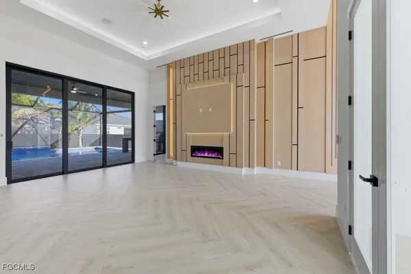 a view of an empty room with a fireplace and a window