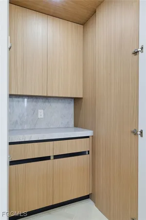 a living room with kitchen view and a fireplace