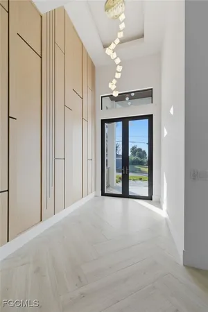 a view of an empty room with a fireplace and window