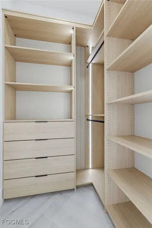 a view of walk in closet with empty racks