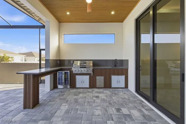 a kitchen with stainless steel appliances granite countertop a sink and a stove