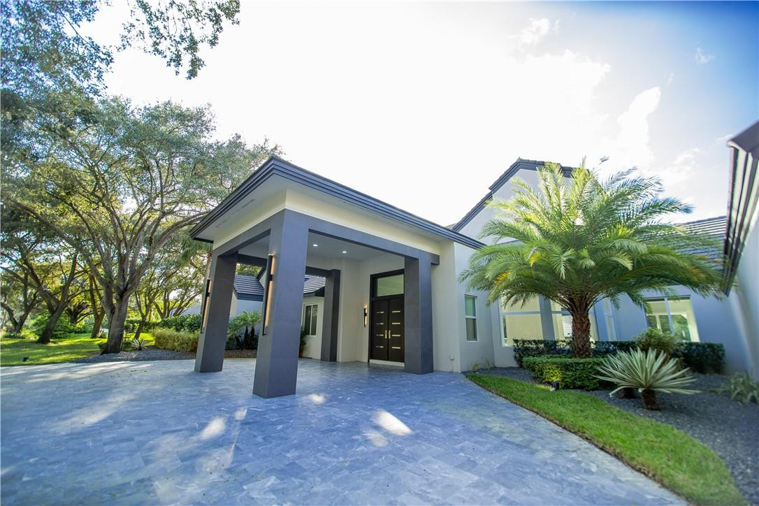 2725 Hackney Road Weston, FL 33331 - Photo 2 of 57 a view of a house with a yard and potted plants