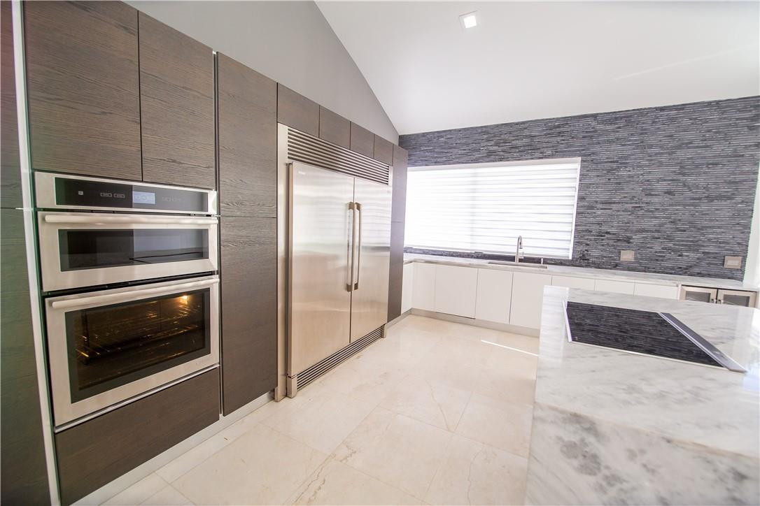 2725 Hackney Road Weston, FL 33331 - Photo 25 of 57 a kitchen with stainless steel appliances granite countertop a refrigerator and a sink