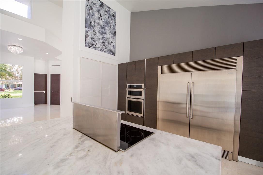 2725 Hackney Road Weston, FL 33331 - Photo 26 of 57 a living room with stainless steel appliances kitchen island granite countertop a refrigerator and cabinets