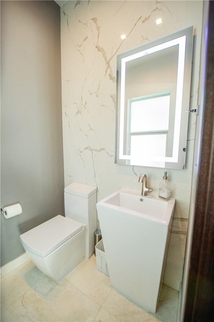 2725 Hackney Road Weston, FL 33331 - Photo 27 of 57 a white toilet sitting next to a bathroom sink