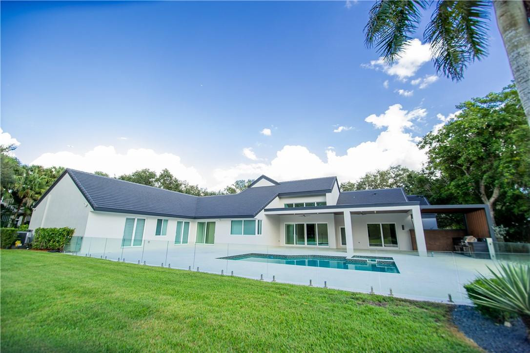 2725 Hackney Road Weston, FL 33331 - Photo 48 of 57 a front view of a house with a garden and yard