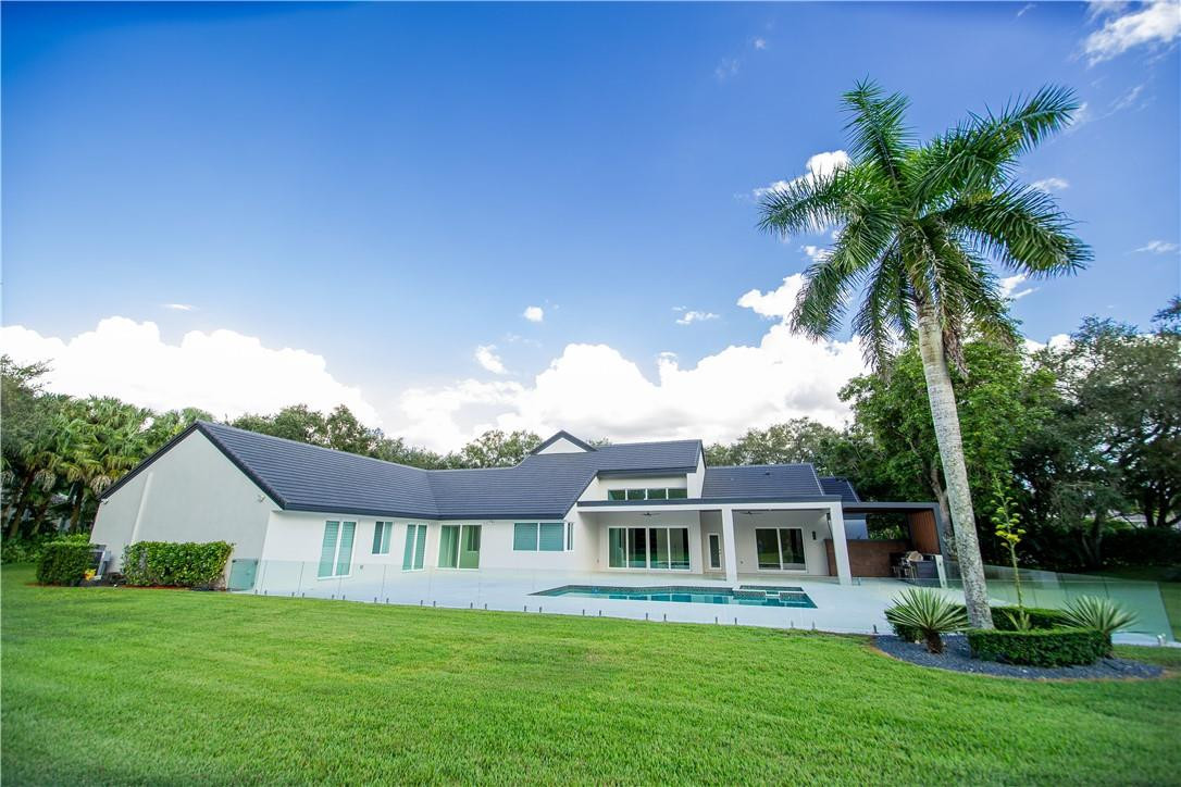 2725 Hackney Road Weston, FL 33331 - Photo 49 of 57 a front view of a house with a garden and plants