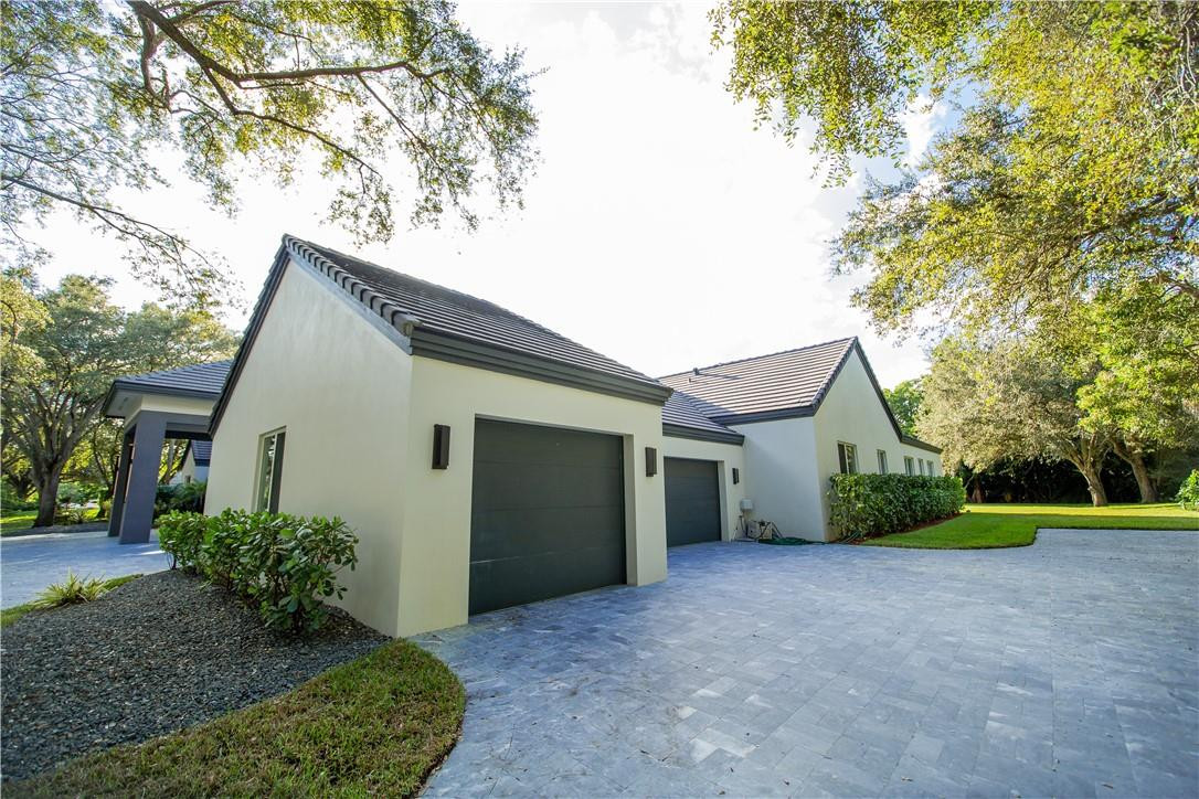 2725 Hackney Road Weston, FL 33331 - Photo 51 of 57 a view of a house with a yard and potted plants