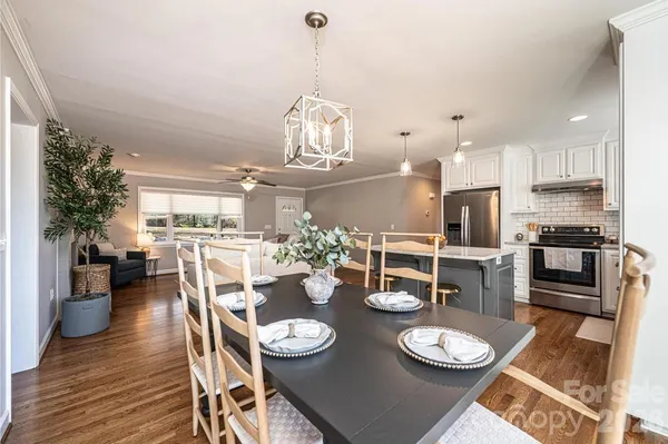 a kitchen with a dining table and chairs