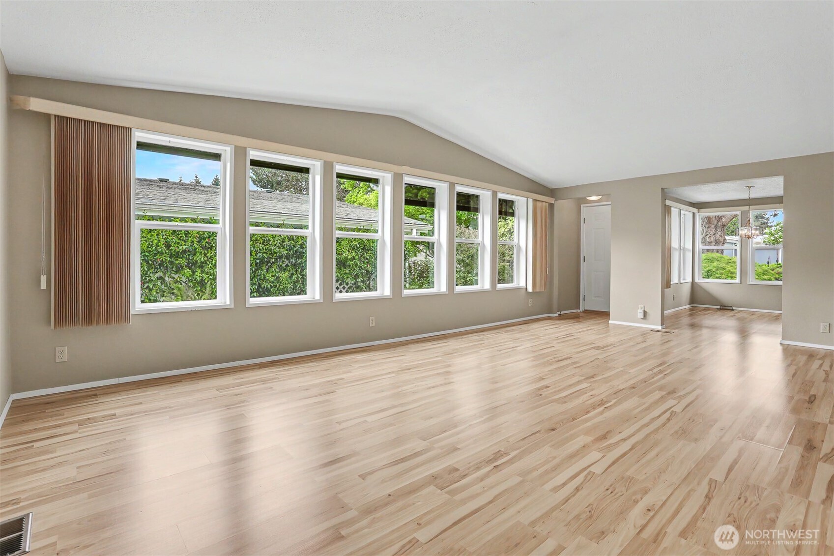 905 243rd Street Southwest Bothell, WA 98021 - Photo 10 of 37 a view of an empty room with wooden floor and a window