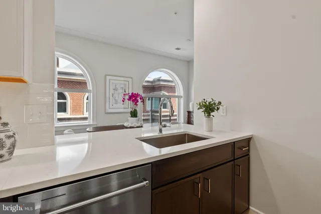 a dining room with furniture and flowers