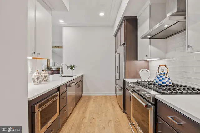 a kitchen with stainless steel appliances granite countertop a stove and a refrigerator