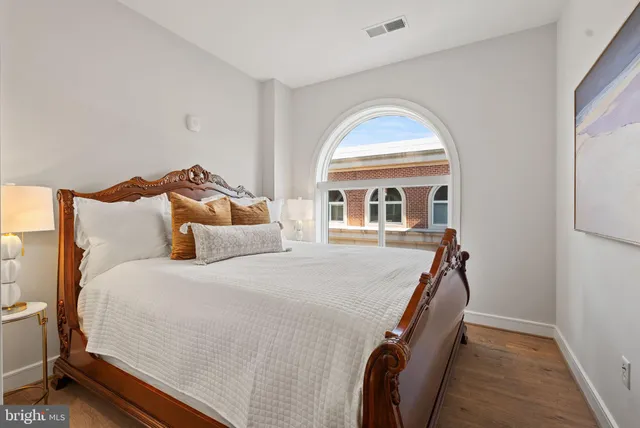 a vase of flowers sitting on a table with a mirror