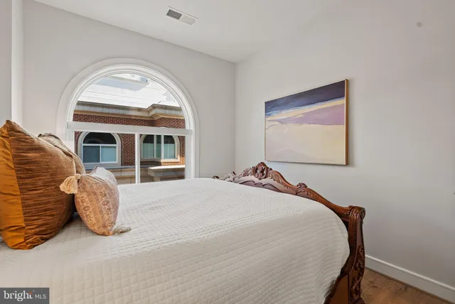 a bedroom with bed and window