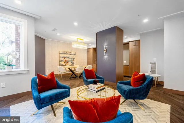 a living room with furniture and a wooden floor