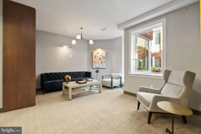 a living room with furniture and a large window